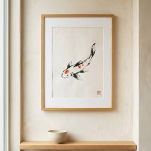 Koi ink koi fish with vermillion accent print styled in a calm Japandi room — warm off-white. Calm & Oak.
