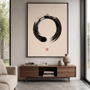 Framed Sumi Enso print displayed above a modern console table in a Japandi-inspired living room with neutral decor.