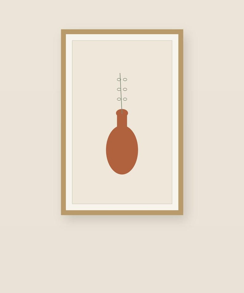 May include: A framed wall art print featuring a solid terracotta-colored oval vase with a thin, vertical line extending upward from the neck, decorated with three small, light-colored circular shapes arranged symmetrically along the stem.