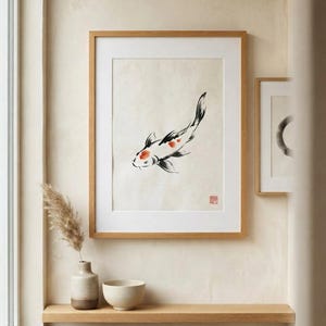 Koi ink koi fish with vermillion accent print styled in a calm Japandi room — warm off-white. Calm & Oak.