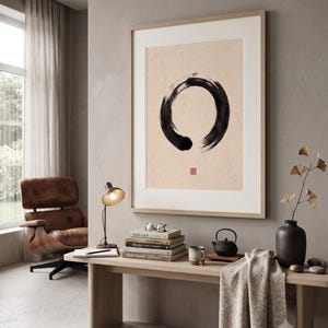 Framed Sumi Enso print displayed above a modern console table in a Japandi-inspired living room with neutral decor.
