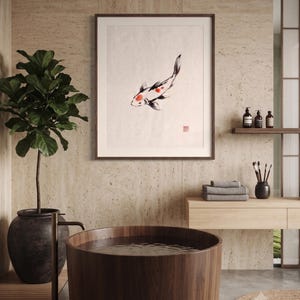 Koi ink koi fish with vermillion accent print styled in a calm Japandi room — warm off-white. Calm & Oak.