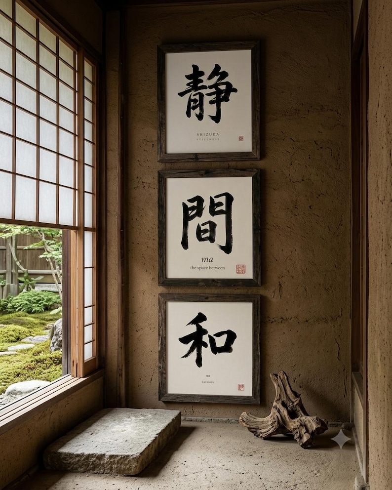Op de afbeelding: Drie vierkante ingelijste kunstwerken aan de muur met zwarte Japanse kalligrafie op een witte achtergrond. Elke print bevat kleinere Engelse tekst en een rood stempel. De donkerhouten lijsten zijn verticaal aan de muur bevestigd.