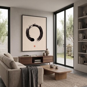 Framed Sumi Enso print displayed above a modern console table in a Japandi-inspired living room with neutral decor.