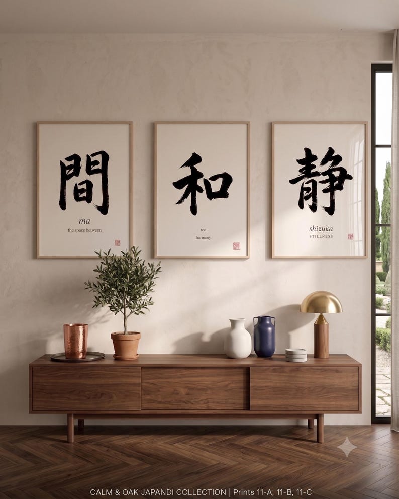 Framed "Ma" calligraphy artwork in a bright neutral living room featuring clean, modern minimalist decor.