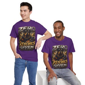 May include: A purple short-sleeved t-shirt featuring a graphic print of a Rottweiler dog wearing a gold chain. The text "ZERO" appears above the dog, and the text "FETCHES GIVEN" appears below the dog in a metallic, weathered font style.