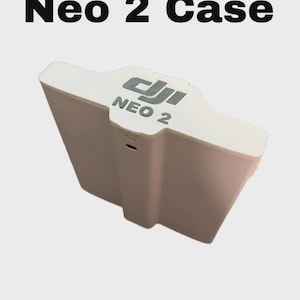 May include: A white DJI Neo 2 case featuring the DJI logo and the text NEO 2 printed on the top surface. The case has a rectangular shape with a slightly contoured top edge and a small circular opening on the front face for device access.