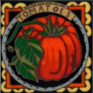 May include: A black and white ceramic tile with a yellow, orange, and red border. The center of the tile features a red tomato with green leaves and the word "TOMATOES" in gold lettering.
