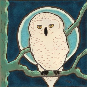 May include: A white snowy owl with yellow eyes perched on a branch against a blue background with a moon behind it.