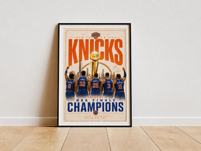 May include: A framed poster featuring the New York Knicks as 2025 NBA Finals Champions. The graphic shows five basketball players in blue jerseys with numbers 8, 32, 25, 3, and 11, standing before a golden trophy and a city skyline silhouette.