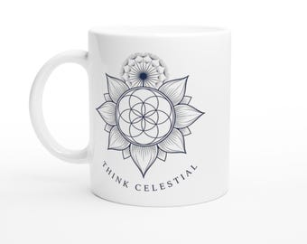 Puede incluir: Una taza de cerámica blanca con un gráfico de líneas azul oscuro de una flor con un patrón geométrico de semilla de la vida en el centro y una cabeza de diente de león encima. El texto THINK CELESTIAL está impreso en azul oscuro debajo.