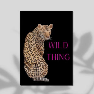 May include: A rectangular wall art print featuring a leopard with tan fur and black spots against a solid black background. The leopard is positioned on the left side, facing right. The text WILD THING is printed in bright pink on the right side.