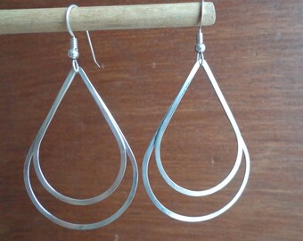 Silver, double teardrop shape earrings.