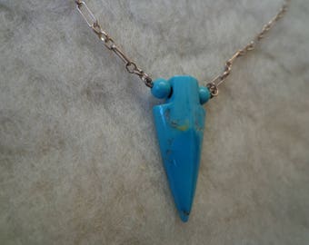 Turquoise, arrow pendant on chain.