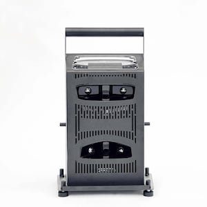 May include: A matte black vertical electronic device featuring a top handle, a rectangular display screen, and two horizontal rows of ventilation slats. The unit is supported by a square base with four small circular feet at each corner.