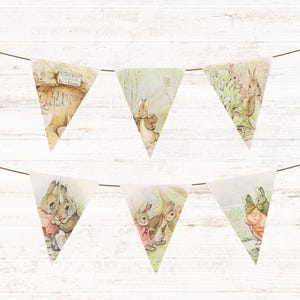 May include: A decorative bunting featuring illustrations of rabbits in a vintage style. The triangular flags depict scenes of rabbits in a garden, with soft pastel colours and a whimsical aesthetic, strung on a thin cord.
