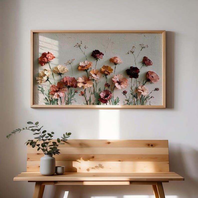 May include: A rectangular wall art piece in a light wood frame featuring a textured impasto painting of various flowers in shades of peach, pink, deep red, and cream against a pale, neutral background with visible brushstrokes and depth.