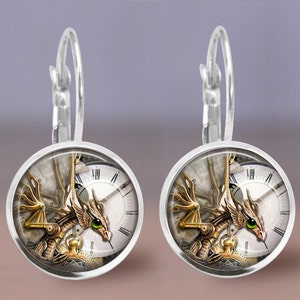 May include: A pair of silver hoop earrings with a round, glass charm featuring a steampunk dragon design. The charm has a clock face with Roman numerals and a gold-toned dragon with green eyes.