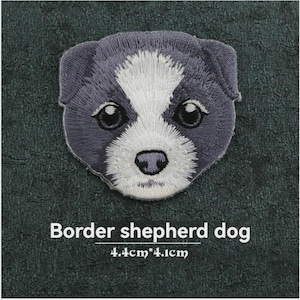 May include: An embroidered patch featuring the face of a Border shepherd dog with dark grey fur and a white blaze on the forehead. The patch measures 4.4cm by 4.1cm. The text below the dog face reads Border shepherd dog 4.4cm*4.1cm.