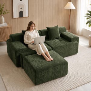May include: A modular dark green corduroy sofa featuring a matching ottoman, wide armrests, and a square throw pillow. The sofa has a tufted seat design and a textured fabric finish, providing a deep seating area for comfort and relaxation.