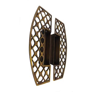 May include: A pair of brass door handles featuring an openwork lattice design with a curved outer edge. Each handle has a rectangular recessed grip area in the center with visible screw holes for mounting, finished in a dark metallic tone.