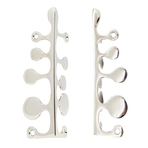 May include: A pair of silver-toned metal earrings featuring an elongated, vertical spine with multiple asymmetrical, rounded, leaf-like protrusions extending from the sides. The design includes small circular loops at the top and bottom ends.