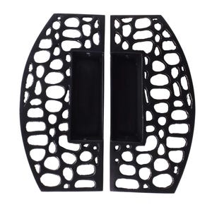 May include: A pair of black metal door handles featuring a cutout design with irregular, organic, pebble-like shapes. Each handle has a central rectangular recessed grip area and a curved outer edge, creating a symmetrical look for double doors.
