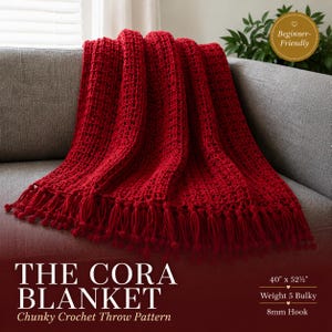 May include: A deep red chunky crochet throw blanket featuring a waffle-like texture and a fringe edge with small pom-poms. The text reads: THE CORA BLANKET, Chunky Crochet Throw Pattern, 40" x 52 1/2", Weight 5 Bulky, 8mm Hook, Beginner-Friendly.