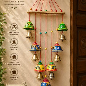 Puede incluir: Una decoración de pared colgante con siete campanas metálicas suspendidas de una barra de madera horizontal mediante cuerdas rojas. Cada campana tiene una cúpula pintada a mano en tonos verde, azul, amarillo y rosa, con pequeñas cuentas.