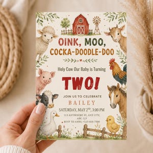 May include: A rectangular birthday invitation card featuring watercolor illustrations of farm animals including a sheep, pig, cow, duck, goat, rooster, horse, and chick. The text reads OINK, MOO, COCKA-DOODLE-DOO, Holy Cow Our Baby is Turning TWO!, BAILEY, and event details.