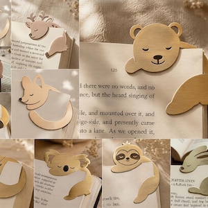 May include: A collection of gold-toned metal bookmarks featuring various animal designs including a cat, deer, bear, raccoon, fox, koala, sloth, and rabbit. Each bookmark is shaped to clip onto the corner of a book page with engraved details.