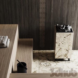 May include: A sauna interior featuring light wood slatted benches, a black bucket, and a tall, rectangular heater encased in white and grey veined marble. The dark wood wall behind the heater displays a vertical, repeating gold Celtic knot pattern.