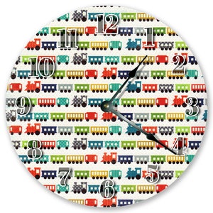 May include: A round clock with a white background and a colorful pattern of toy trains. The clock face has black numbers and hands.