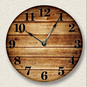 May include: A round wooden clock with black Roman numeral hour markers and black hands. The clock face has a wood grain pattern.
