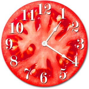 May include: A red tomato slice clock with white numbers and hands. The clock face is a close-up of a tomato slice with visible seeds.