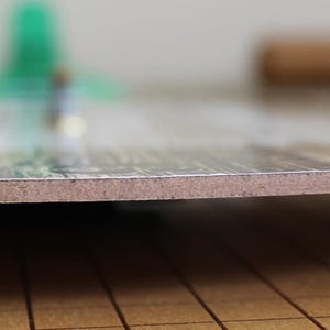 A close-up view of a wooden surface with a textured, wooden-like appearance.