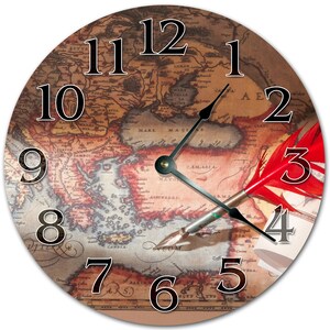 May include: A round clock with a vintage map design. The clock face features Roman numerals and a black and white quill pen with a red feather. The map shows the Mediterranean Sea and surrounding areas.