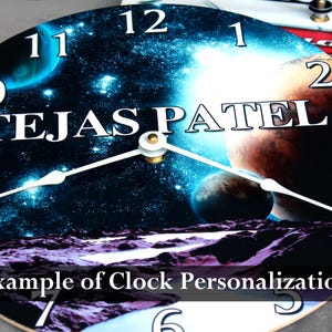 A clock with a space-themed design, featuring planets, stars, and a planet-like object. The text "TEJASPATEL" is prominently displayed on the clock face.