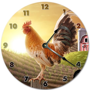 May include: A round clock with a rooster illustration. The rooster is standing on a fence post with a field of green grass and a red barn in the background. The clock face has black Roman numeral hour markers and black hands.