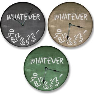 May include: Three round clocks with a chalkboard-style design. Each clock has the word "WHATEVER" written in white chalk on the face. The clocks are black, brown, and green.