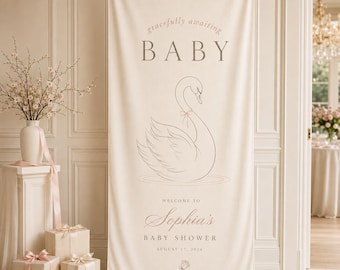 May include: A cream-colored fabric banner featuring a line-art illustration of a swan with a small bow. The text reads: gracefully awaiting BABY, WELCOME TO Sophia's BABY SHOWER, AUGUST 17, 2026, and a small rose illustration at the bottom.