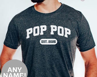 May include: Dark heather gray t-shirt with white text that reads "Pop Pop Est. 2025".