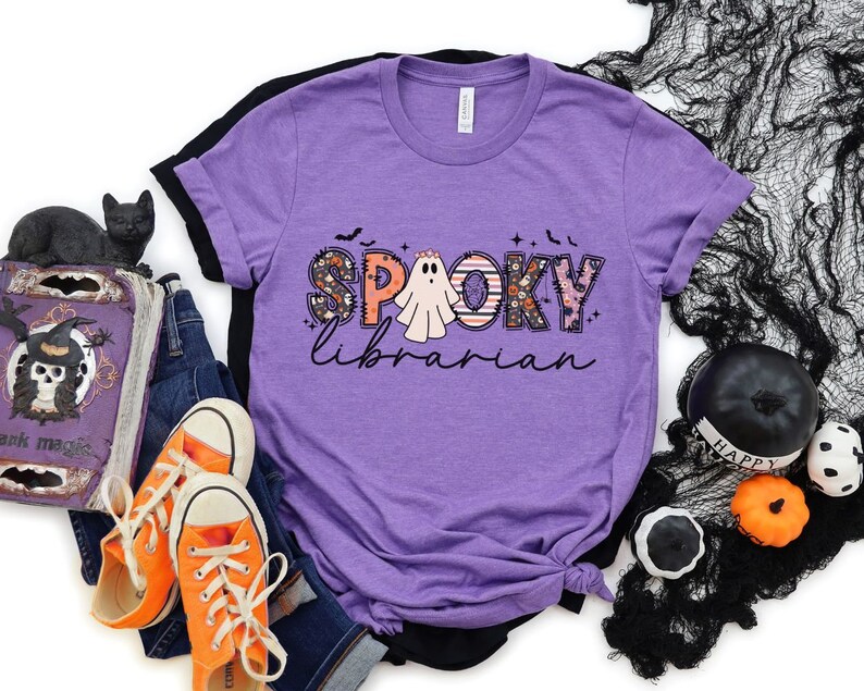 May include: Purple t-shirt with a graphic of a ghost and the text "Spooky Librarian".