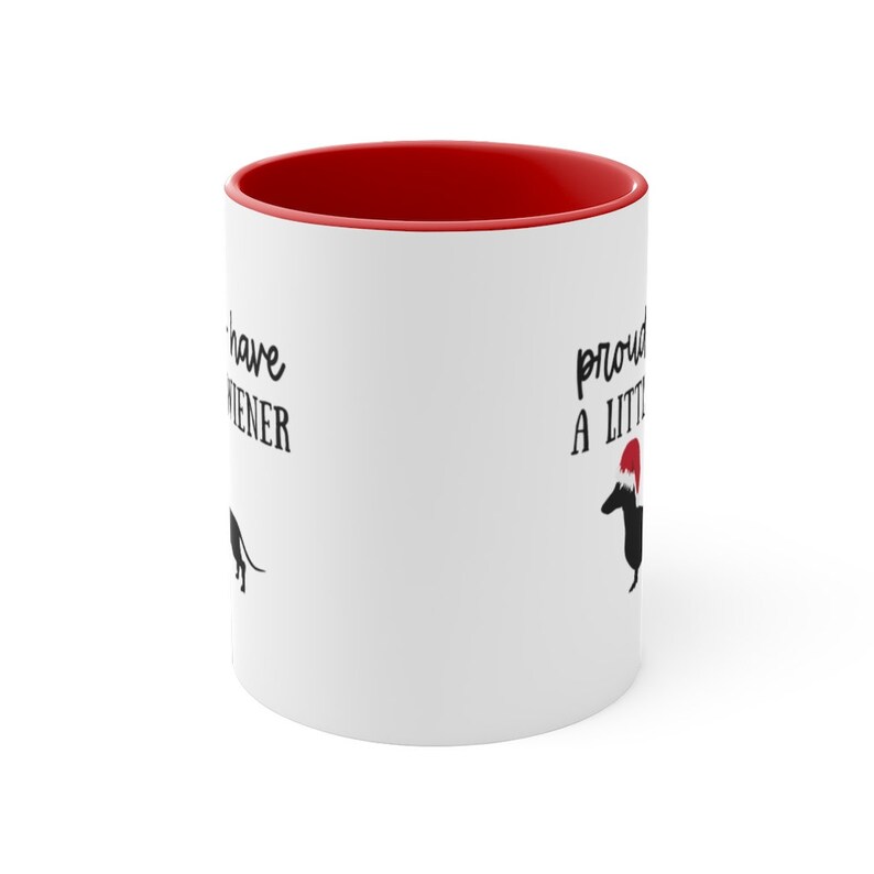 May include: White ceramic mug with a red interior. The mug features black text that reads "I have a wiener" and "proud to have a little wiener" with a dachshund illustration.