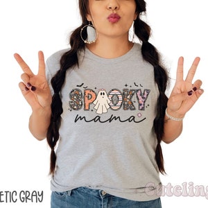May include: A gray t-shirt with the text "Spooky mama" in colorful letters with a ghost and other Halloween-themed designs.