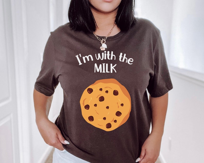 May include: A brown t-shirt with the text "I'm with the MILK" and a chocolate chip cookie graphic.