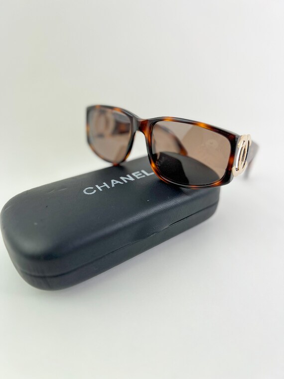 Vintage CHANEL brown frame sunglasses with large CC charms at