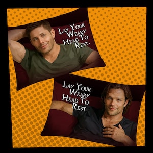 May include: Two decorative pillow covers featuring images of men, each reclining on a pillow. The pillows are framed by a dark burgundy border and the text "Lay Your Weary Head To Rest." The background is a pattern of orange polka dots.