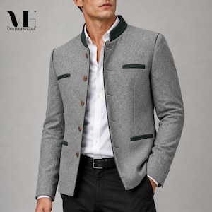 May include: A grey wool-blend blazer featuring a dark green mandarin collar and matching dark green pocket trim. The jacket includes a front button closure with brown buttons, a white button-down shirt underneath, and black trousers with a belt.
