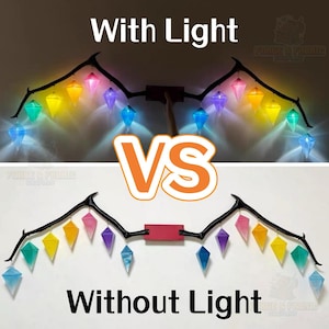 May include: A black branch-like wall mount featuring multiple hanging translucent geometric crystals in various colors. The top section shows the crystals illuminated with internal lights, while the bottom section shows them without illumination.